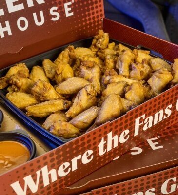 a large red miller's ale house branded box with chicken wings and sauces inside