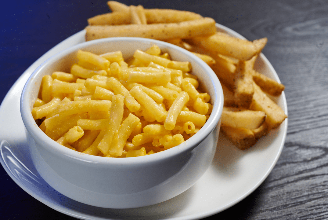 a bowl of Mac and cheese and French fries