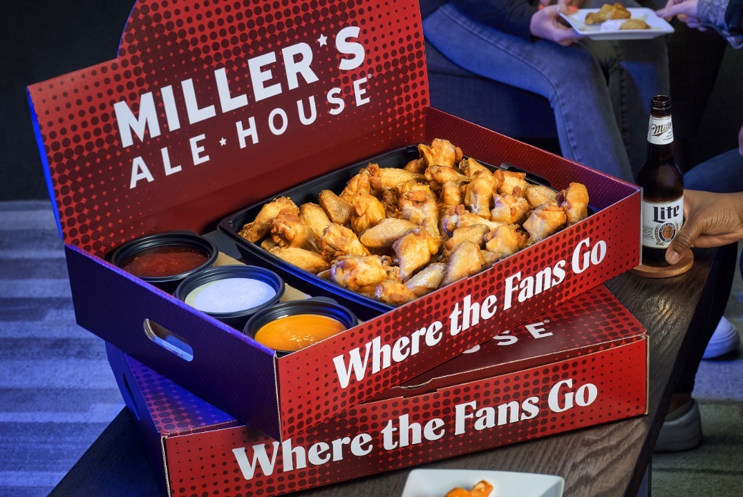 a large red miller's ale house branded box with chicken wings and sauces inside