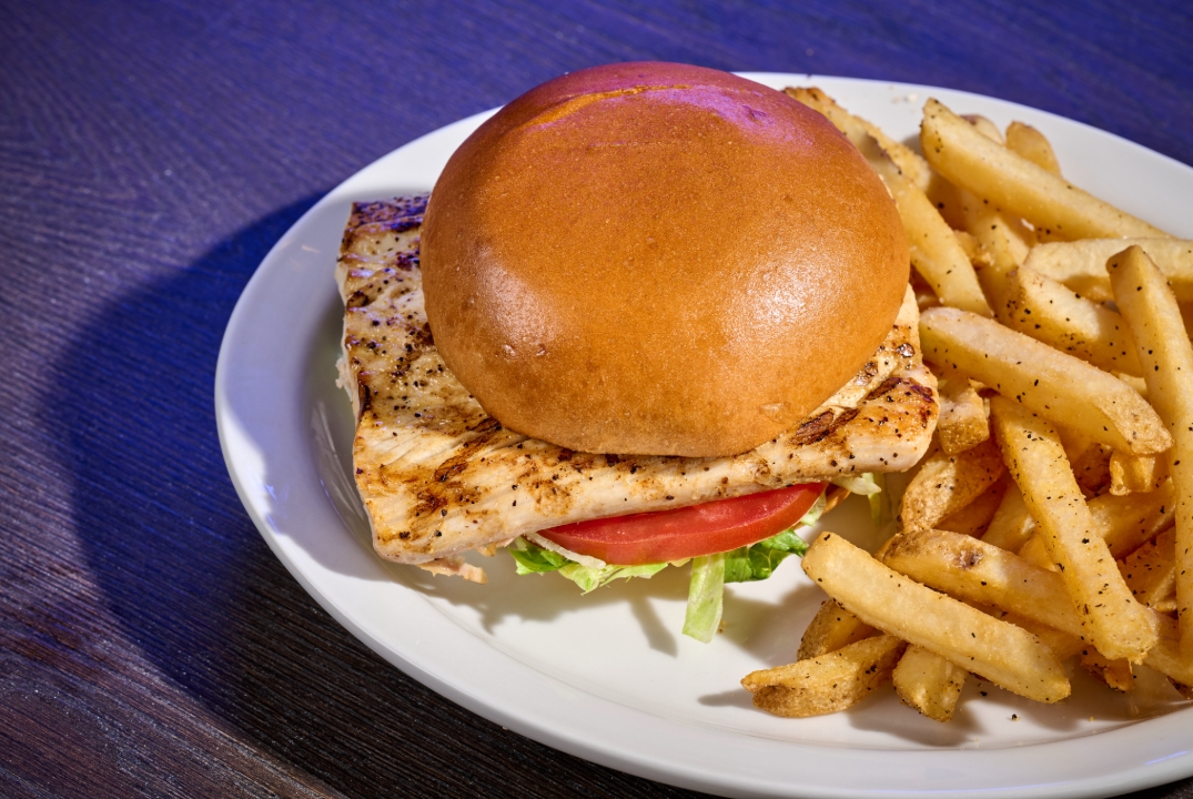 Mahi Mahi Sandwich from Miller's Ale House on a plate with Fries