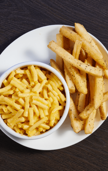 a bowl of Mac and cheese and French fries